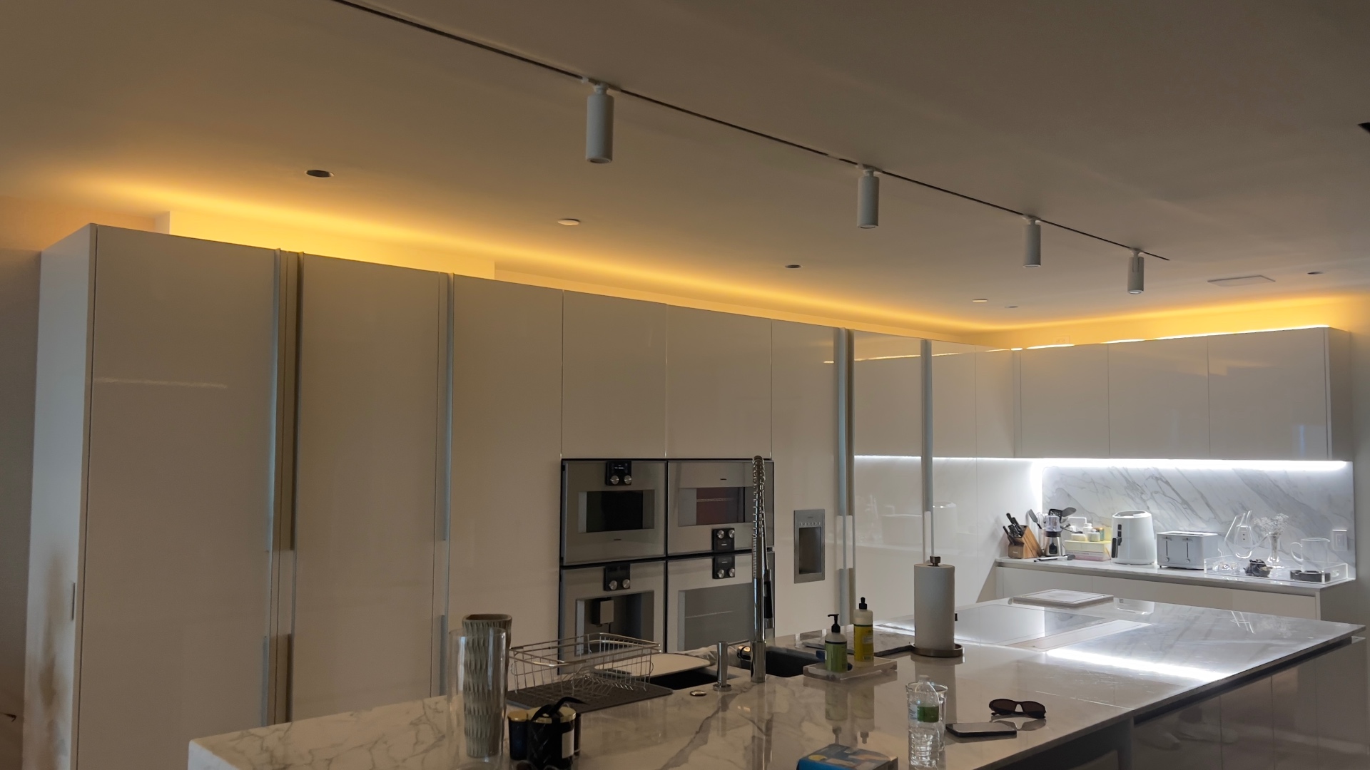 High-gloss white kitchen with integrated appliances in Sunny Isles Beach
