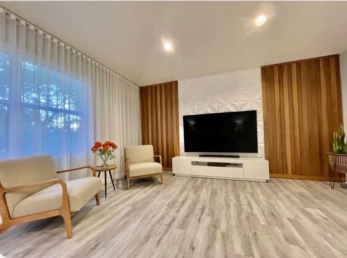 Custom wood slat feature wall with integrated television in a Miami living room