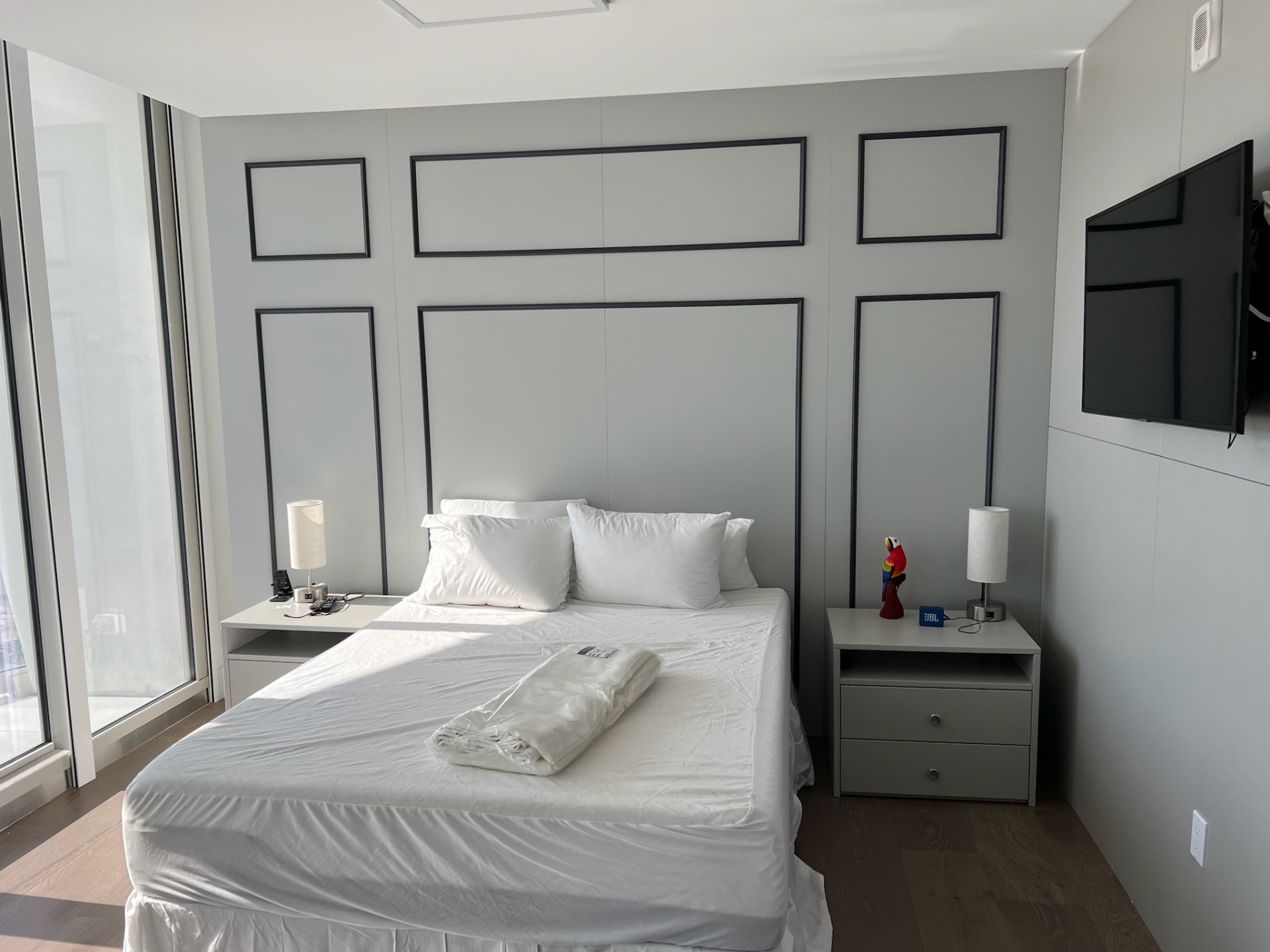 Installed panelled bedroom wall with integrated sconces in Sunny Isles